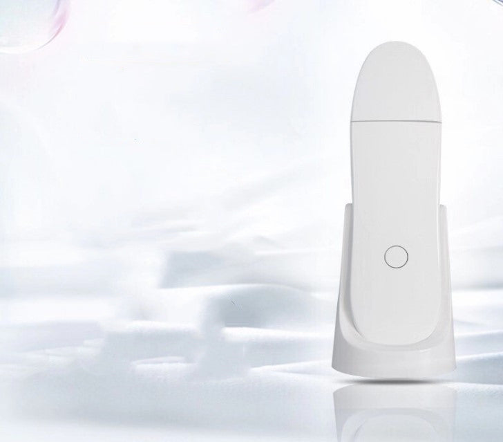 White electronic device on a reflective white surface with a blurred background