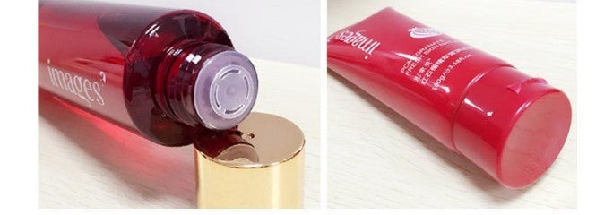 Red cosmetic bottle with gold cap on a white background