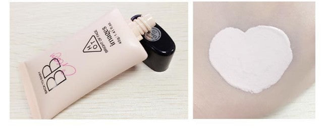 Cosmetic bottle and heart-shaped pad on a light background