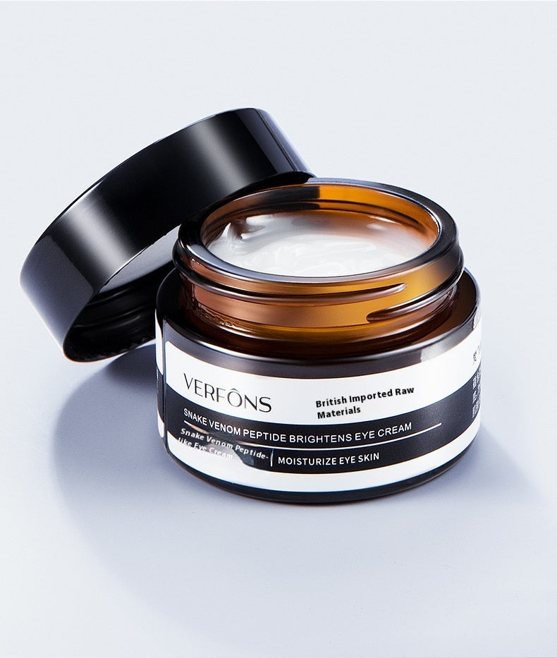 Open jar of Verfons eye cream on a light gray background