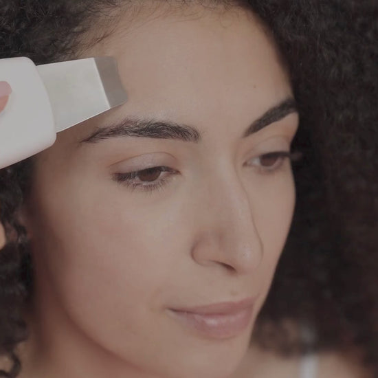 Lady using Veluva's Ultrasonic facial Cleanser 