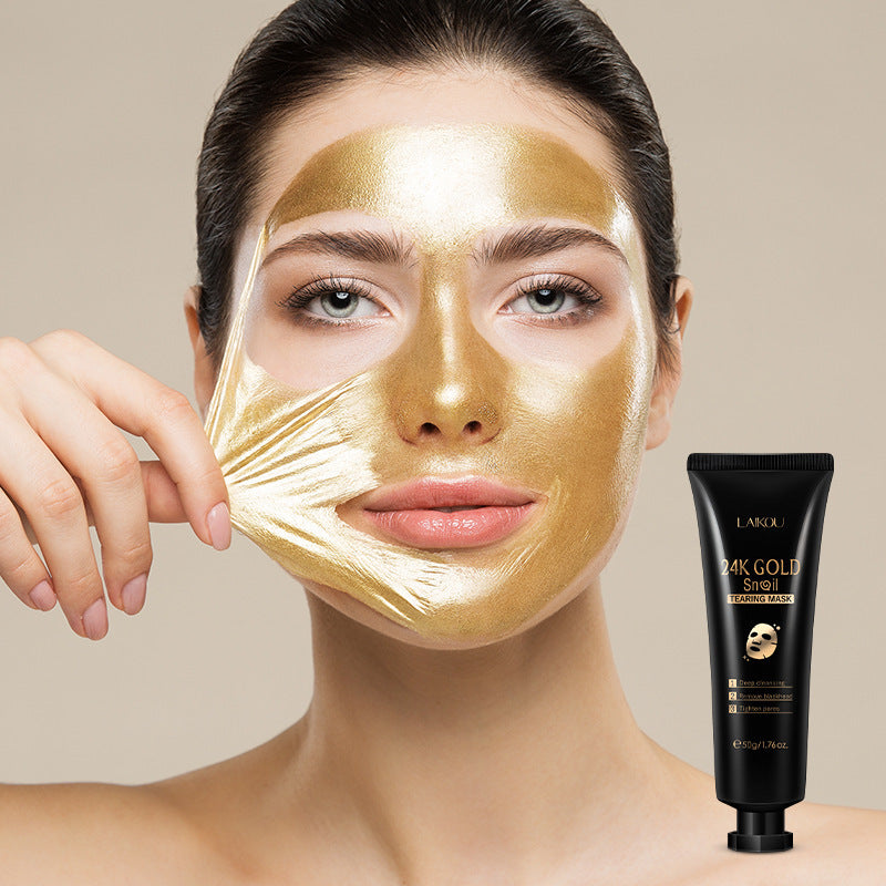 Woman wearing a gold face mask with a L'ANZA product on a beige background
