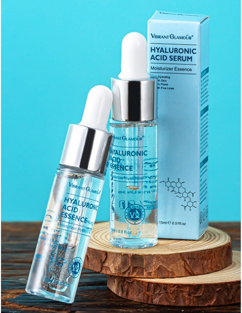 Hyaluronic Acid Serum with dropper and packaging on a wooden stand against a blue background