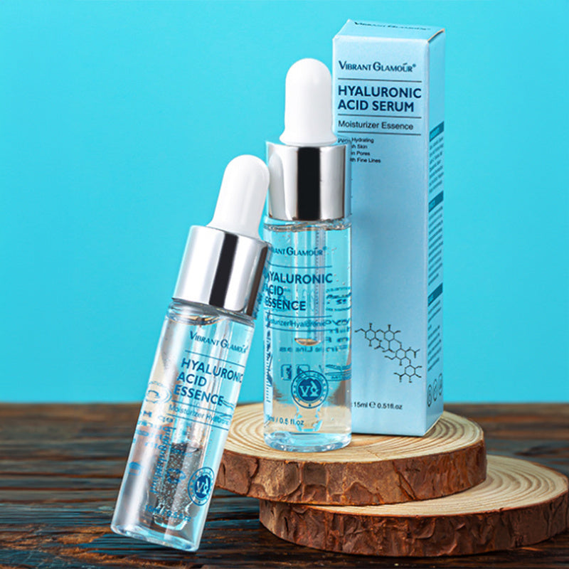 Hyaluronic acid serum with dropper and packaging on a wooden stand against a blue background