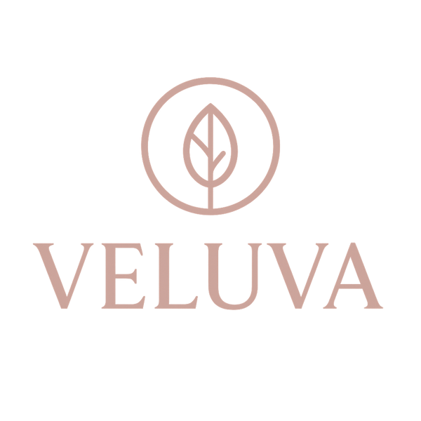 Veluva logo with a leaf design on a light pink background