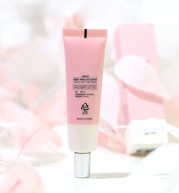 Pink skincare tube with white cap on a soft pink background