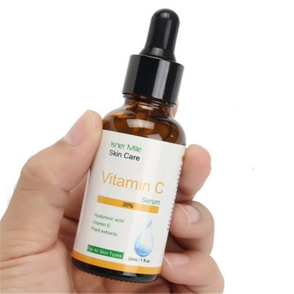 Hand holding a bottle of Isner Mile Vitamin C Serum on a white background