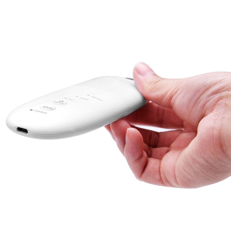 Hand holding a white electronic device on a white background