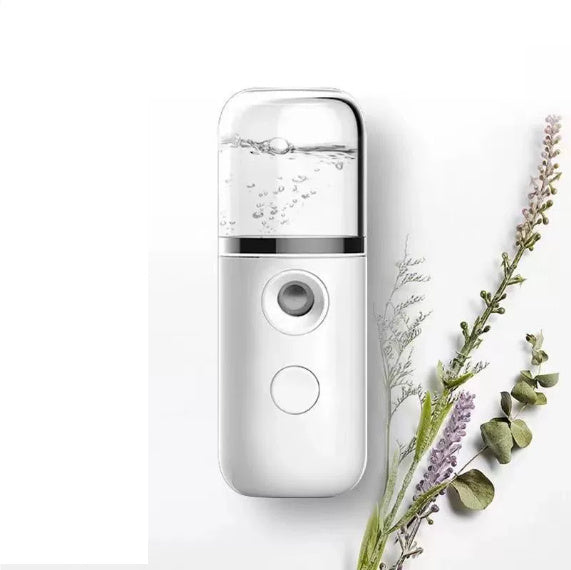 White handheld device with a clear top section on a white background with greenery.