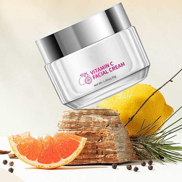 Vitamin C facial cream jar with citrus fruits and spices on a light background