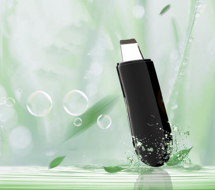 Black electronic device on a green background with leaves and bubbles
