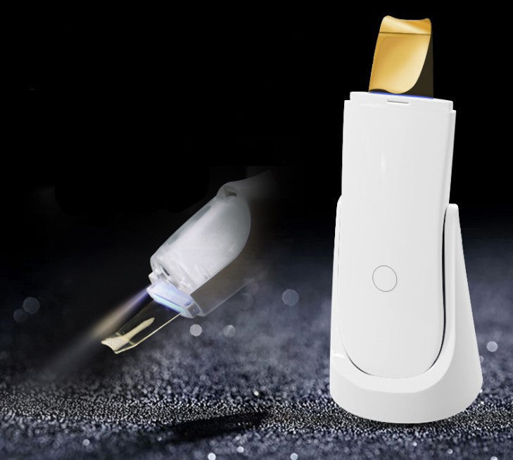 White electronic device with gold component on a dark background